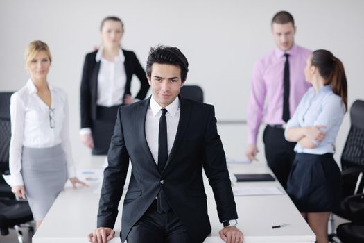 Confident young business man attending a meeting with his colleagues