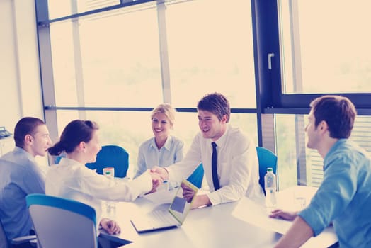 Group of happy young  business people in a meeting at office