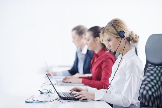 Pretty young business woman group with headphones smiling at you against white background