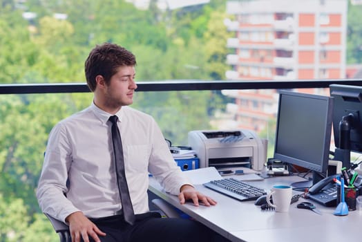 happy young business  man work in modern office on computer