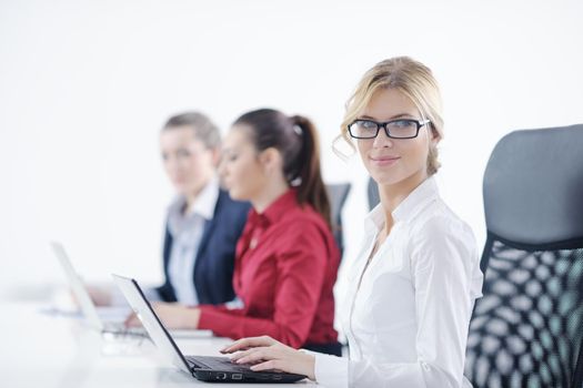 Pretty young business woman group with headphones smiling at you against white background