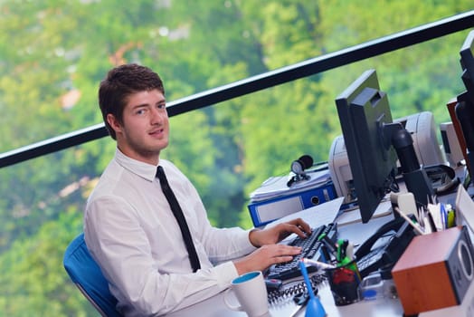 happy young business  man work in modern office on computer