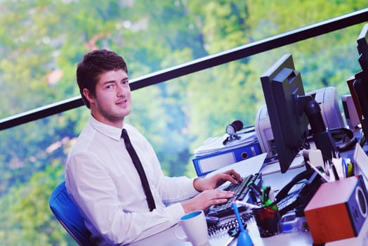 happy young business  man work in modern office on computer