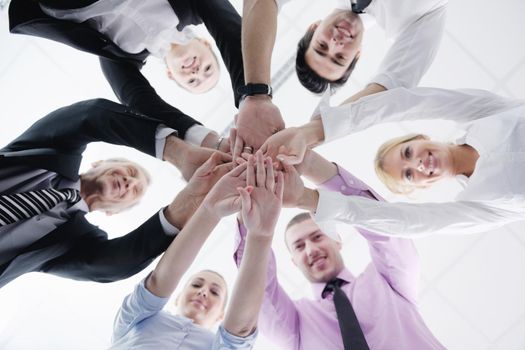 business people group joining hands and representing concept of friendship and teamwork,  low angle view