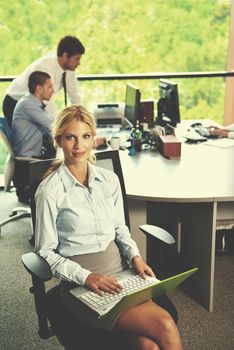 business woman  with her staff,  people group in background at modern bright office indoors