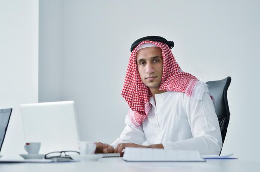 happy young arabic business man working at bright office