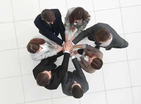 top view.business team joining hands together.the concept of teamwork