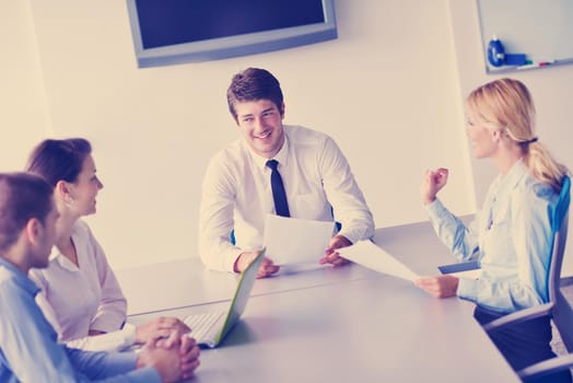 Group of happy young  business people in a meeting at office