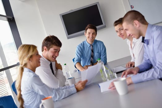 Group of happy young  business people in a meeting at office