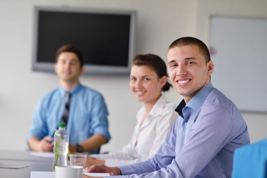 Group of happy young  business people in a meeting at office