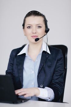 Pretty young business woman group with headphones smiling at you against white background