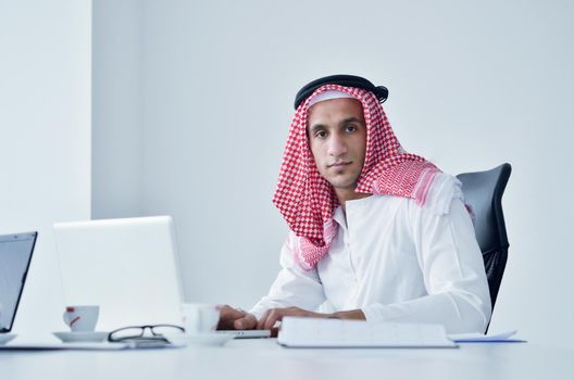 happy young arabic business man working at bright office