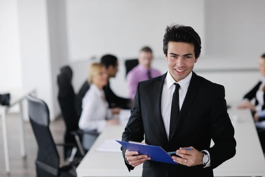 Confident young business man attending a meeting with his colleagues