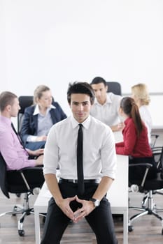 Confident young business man attending a meeting with his colleagues