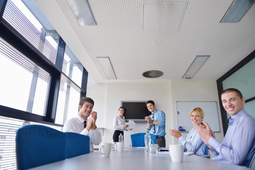 Group of happy young  business people in a meeting at office