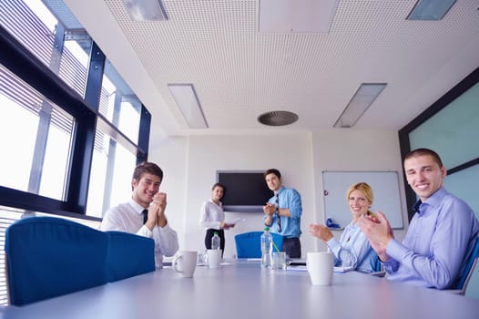 Group of happy young  business people in a meeting at office