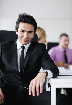 Confident young business man attending a meeting with his colleagues