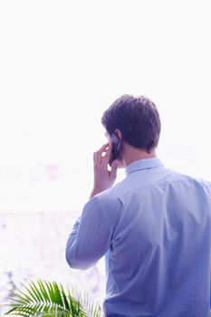 business man talking by cellphone in office