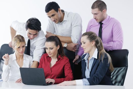 Group of young business people sitting in board room during meeting and discussing with paperwork