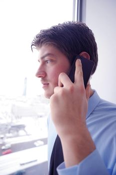 business man talking by cellphone in office