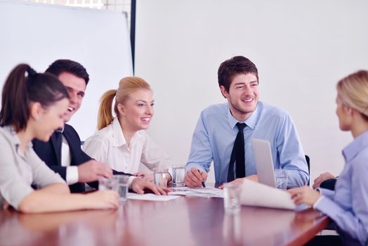 Group of happy young  business people in a meeting at office