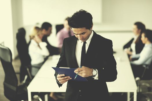 Confident young business man attending a meeting with his colleagues