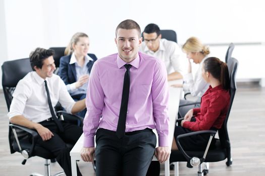 Confident young business man attending a meeting with his colleagues