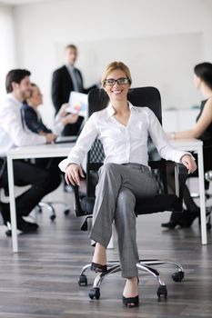 business woman  with her staff,  people group in background at modern bright office indoors