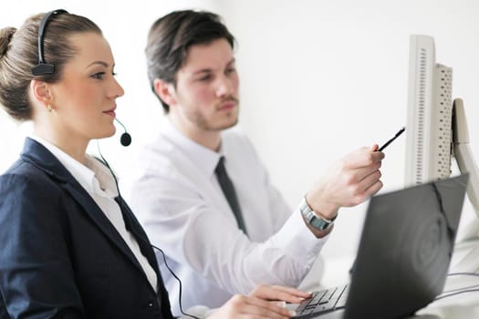 business people group with  headphones giving support in  help desk office to customers, manager giving training and education instructions