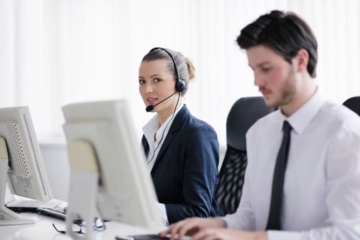 business people group with  headphones giving support in  help desk office to customers, manager giving training and education instructions