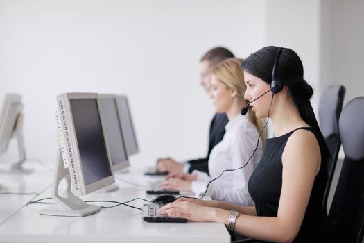 business people group with  headphones giving support in  help desk office to customers, manager giving training and education instructions