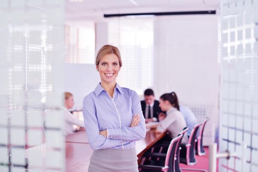 business woman  with her staff,  people group in background at modern bright office indoors