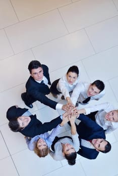 business people group joining hands and stay as team in circle  and representing concept of friendship and teamwork