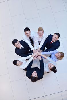 business people group joining hands and stay as team in circle  and representing concept of friendship and teamwork