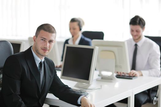 business people group with  headphones giving support in  help desk office to customers, manager giving training and education instructions