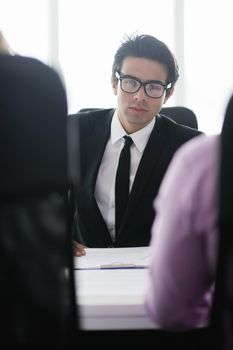 Confident young business man attending a meeting with his colleagues