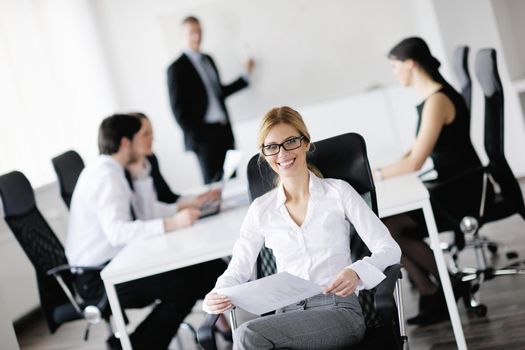 business woman  with her staff,  people group in background at modern bright office indoors