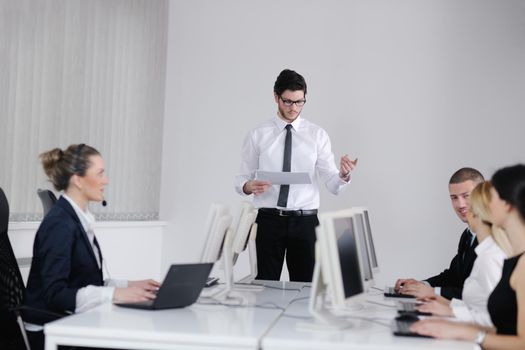 business people group with  headphones giving support in  help desk office to customers, manager giving training and education instructions