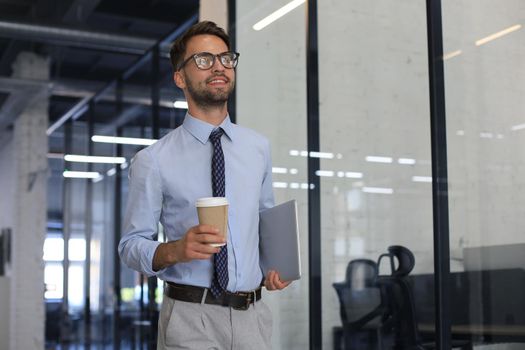 Young handsome businessman smiling in an office environment