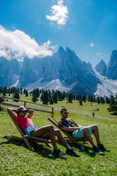 Geisler Alm, Dolomites Italy, hiking in the mountains of Val Di Funes in Italian Dolomites,Nature Park Geisler-Puez with Geisler Alm in South Tyrol. Italy Europe, couple man and woman hiking mountains