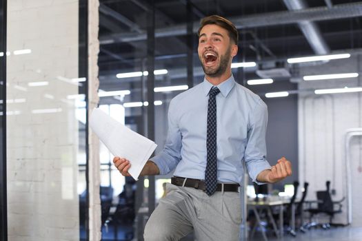 Excited business man celebrating success in the office
