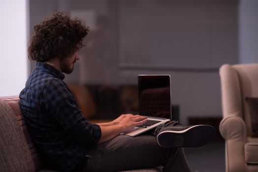 technology, home and lifestyle concept  of man working with laptop computer and sitting on sofaa