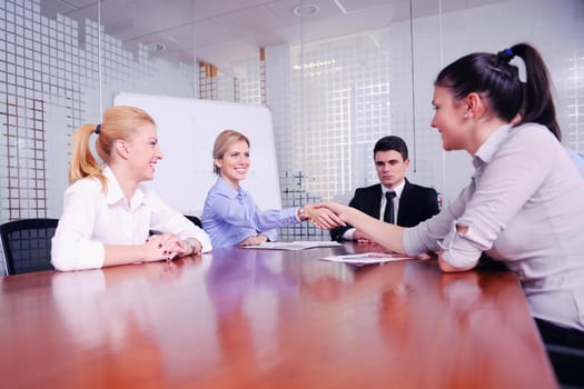 Group of happy young  business people in a meeting at office