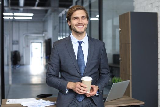 Young handsome businessman smiling in an office environment