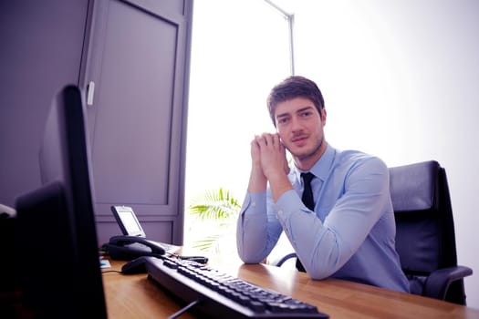 happy young business  man work in modern office on computer