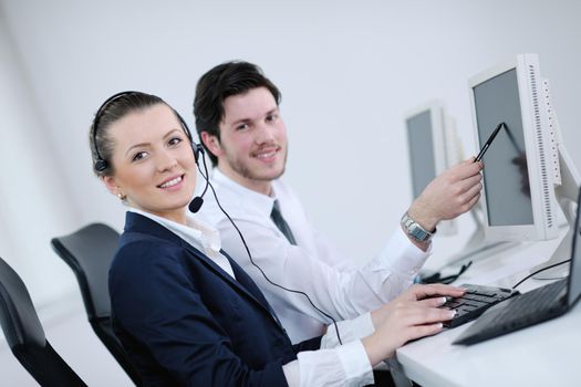 business people group with  headphones giving support in  help desk office to customers, manager giving training and education instructions