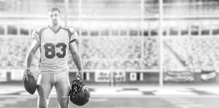 American Football Player isolated on big modern stadium field with lights and flares