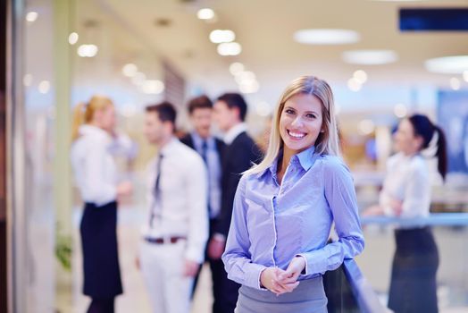 business woman  with her staff,  people group in background at modern bright office indoors