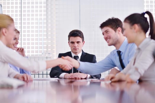 Group of happy young  business people in a meeting at office