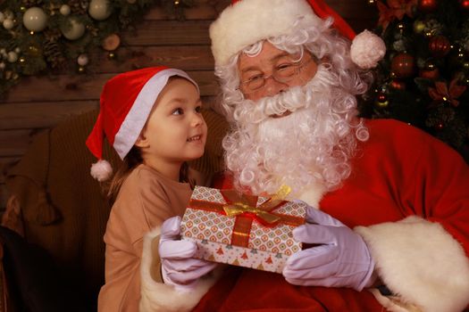 Santa Claus and child at home. Christmas gift. Family holiday concept